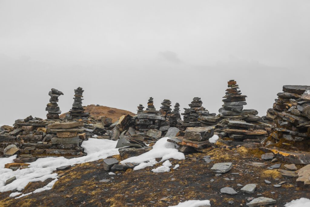 Cairns built on a misty mountain top. Prosper. Defining Performance