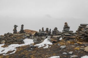 Cairns built on a misty mountain top. Prosper. Defining Performance